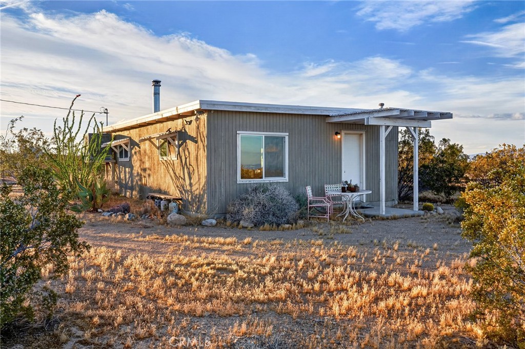 437 Mallow Road Landers, CA 92285 - Photo 30 of 52 a view of house with backyard and porch