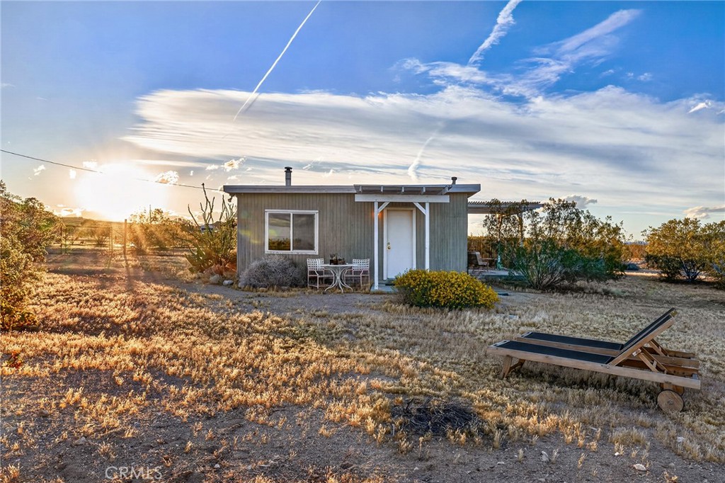 437 Mallow Road Landers, CA 92285 - Photo 42 of 52 a backyard of a house with yard and outdoor seating