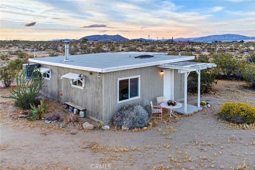 437 Mallow Road Landers, CA 92285 - Photo 6 of 52 a view of a terrace with a table and chairs