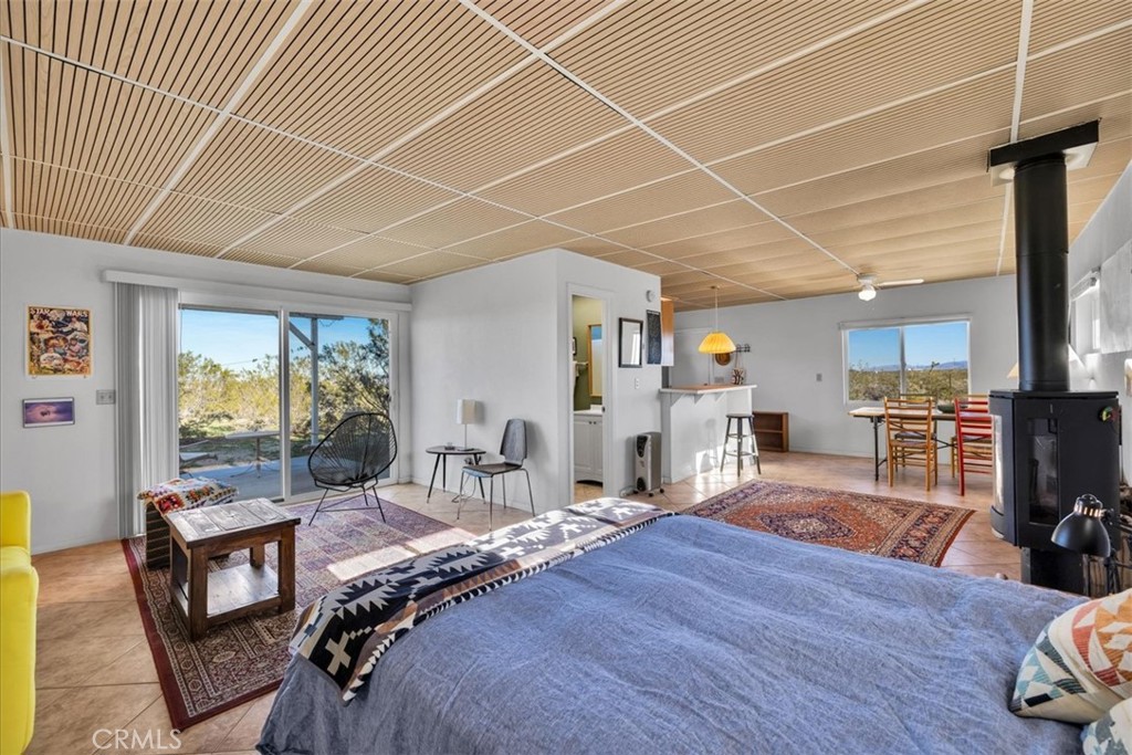 437 Mallow Road Landers, CA 92285 - Photo 7 of 52 a bedroom with furniture and a large window