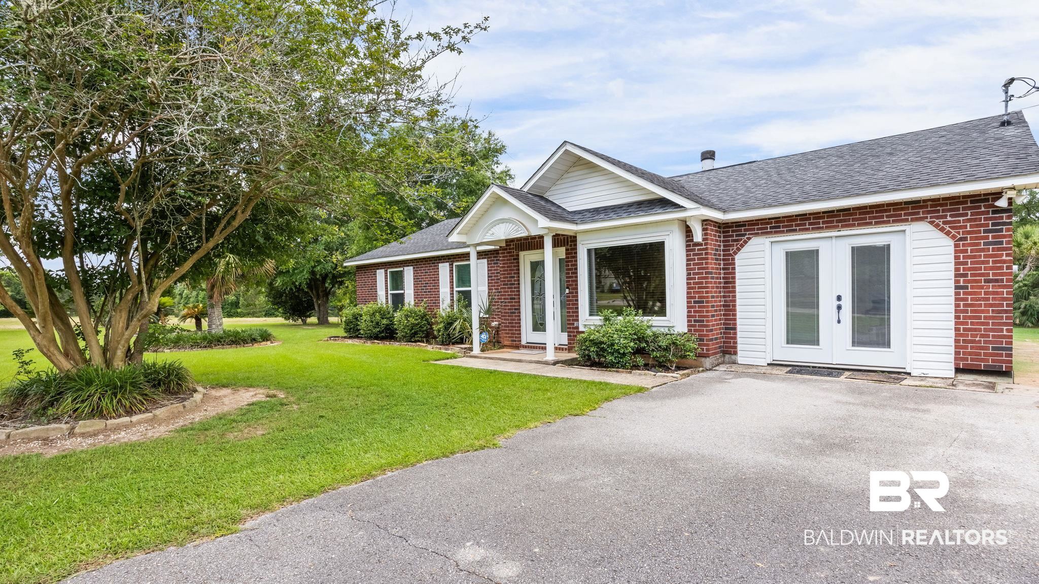 15096 Highland Circle Foley, AL 36535 - Photo 3 of 52 Brick exterior with white siding accents and a contrasting dark roof