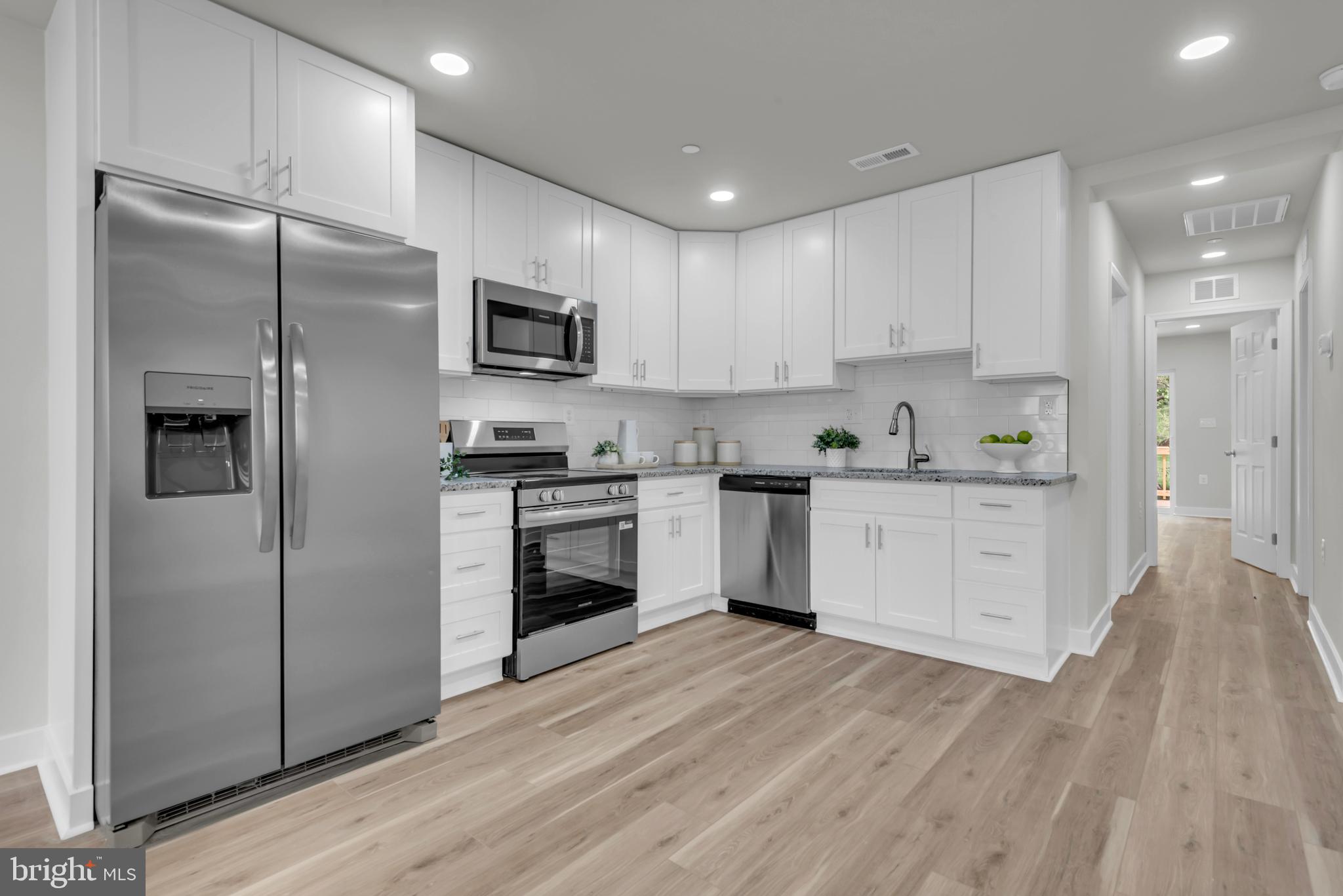 928 Riversedge Circle Annapolis, MD 21401 - Photo 15 of 37 a kitchen with white cabinets and stainless steel appliances