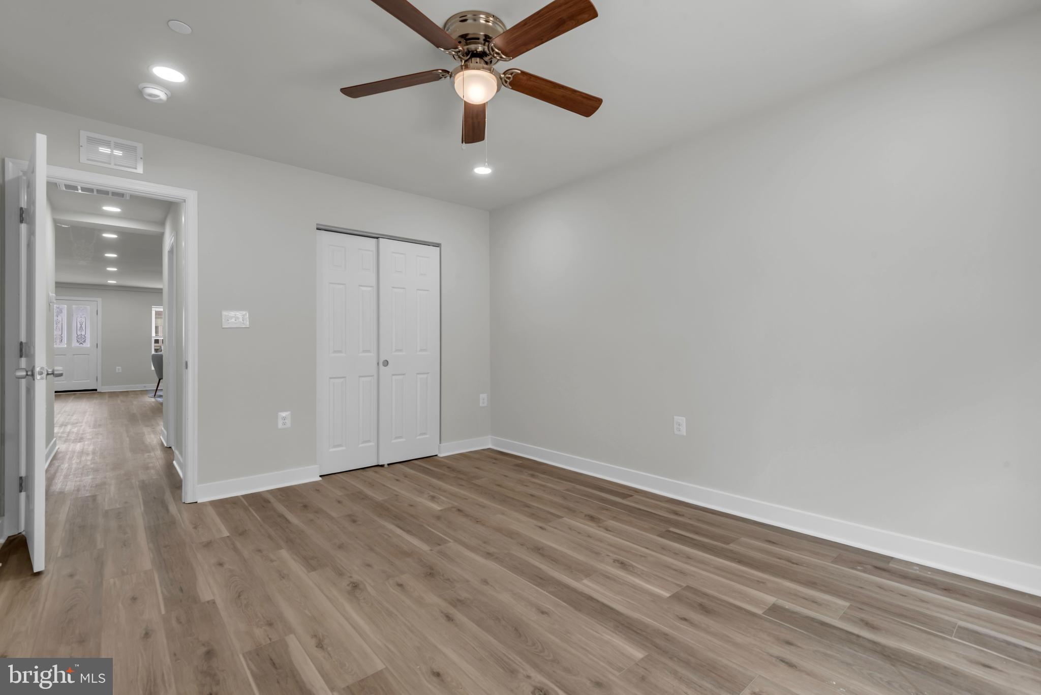 928 Riversedge Circle Annapolis, MD 21401 - Photo 24 of 37 wooden floor in an empty room with a fan