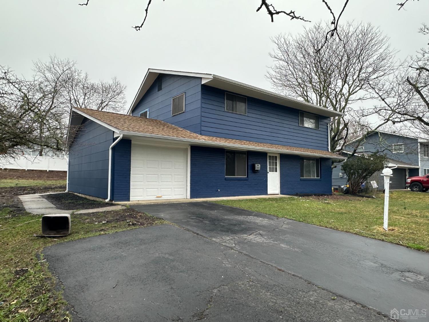45 Raleigh Road Kendall Park, NJ 08824 - Photo 1 of 13 a front view of a house with garage