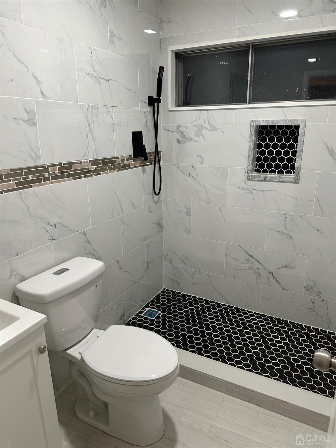 45 Raleigh Road Kendall Park, NJ 08824 - Photo 11 of 13 a bathroom with a toilet and a shower