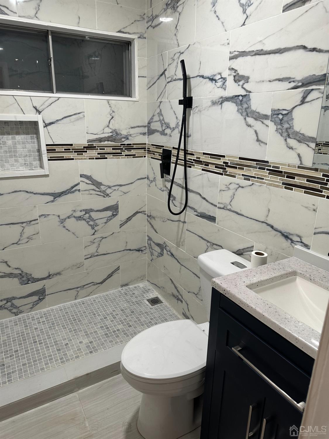 45 Raleigh Road Kendall Park, NJ 08824 - Photo 12 of 13 a bathroom with a granite countertop toilet sink and mirror