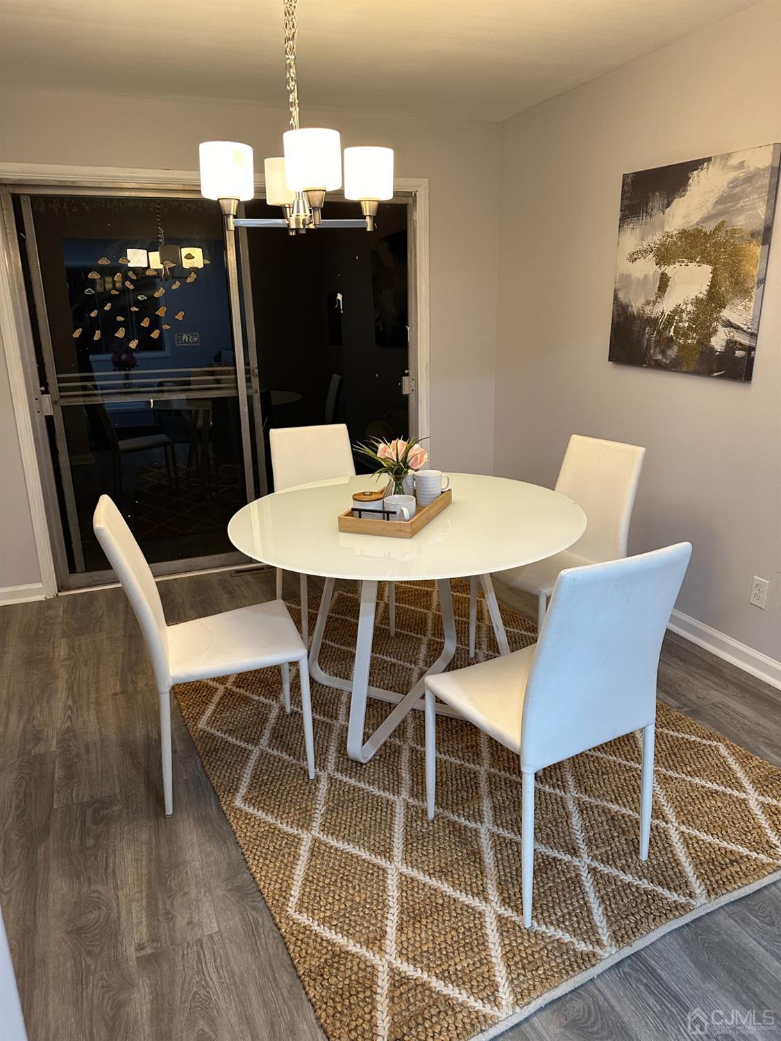 45 Raleigh Road Kendall Park, NJ 08824 - Photo 7 of 13 a view of a dining room with furniture and wooden floor