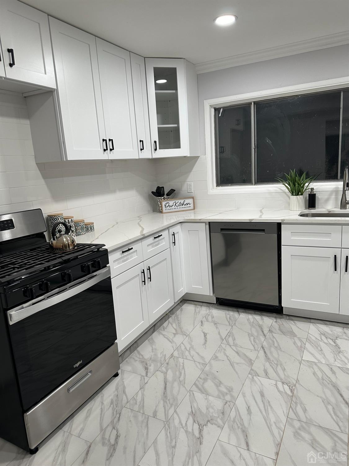 45 Raleigh Road Kendall Park, NJ 08824 - Photo 8 of 13 a kitchen with stainless steel appliances granite countertop a sink and a stove