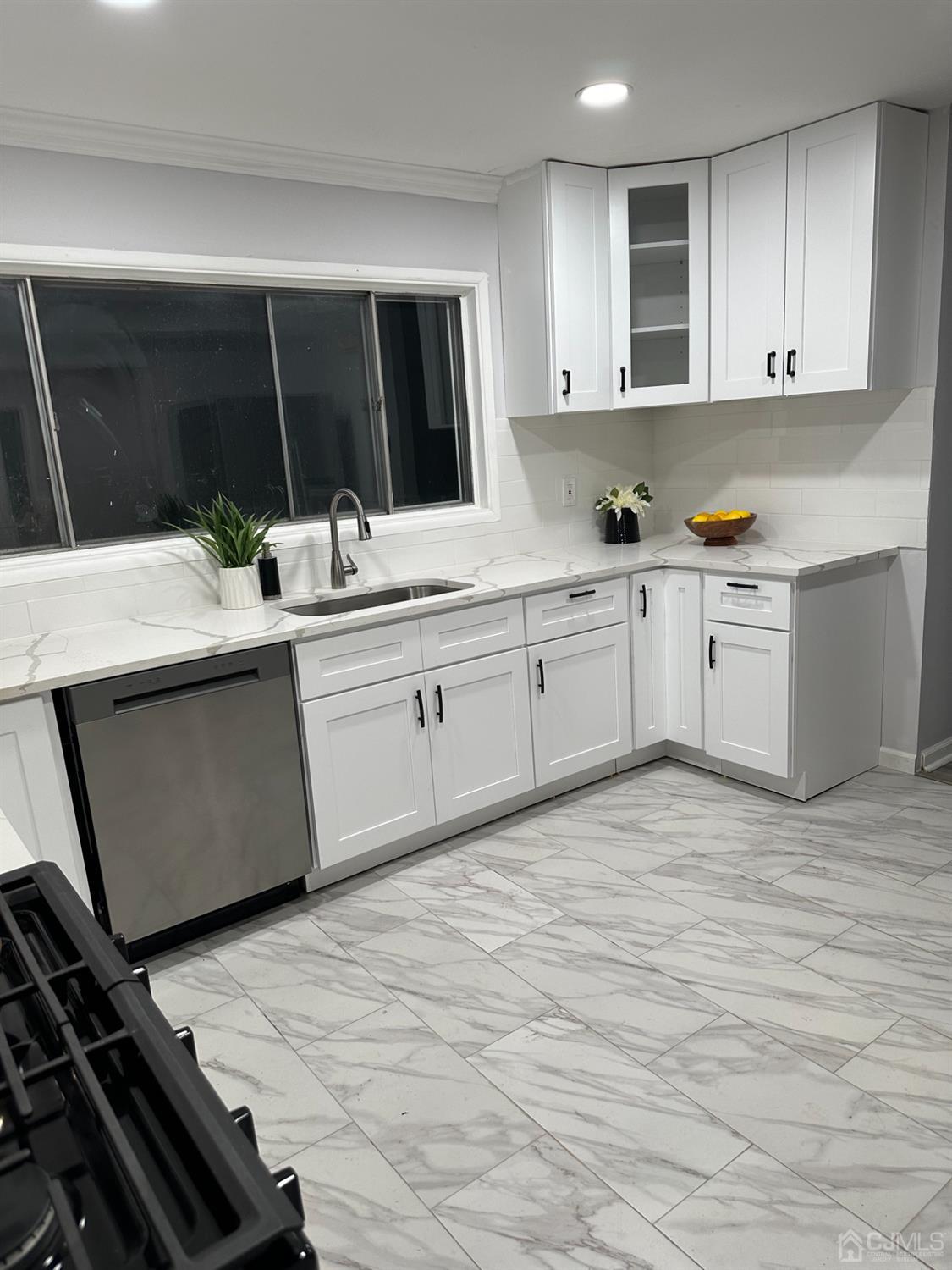 45 Raleigh Road Kendall Park, NJ 08824 - Photo 9 of 13 a kitchen with granite countertop a sink and cabinets