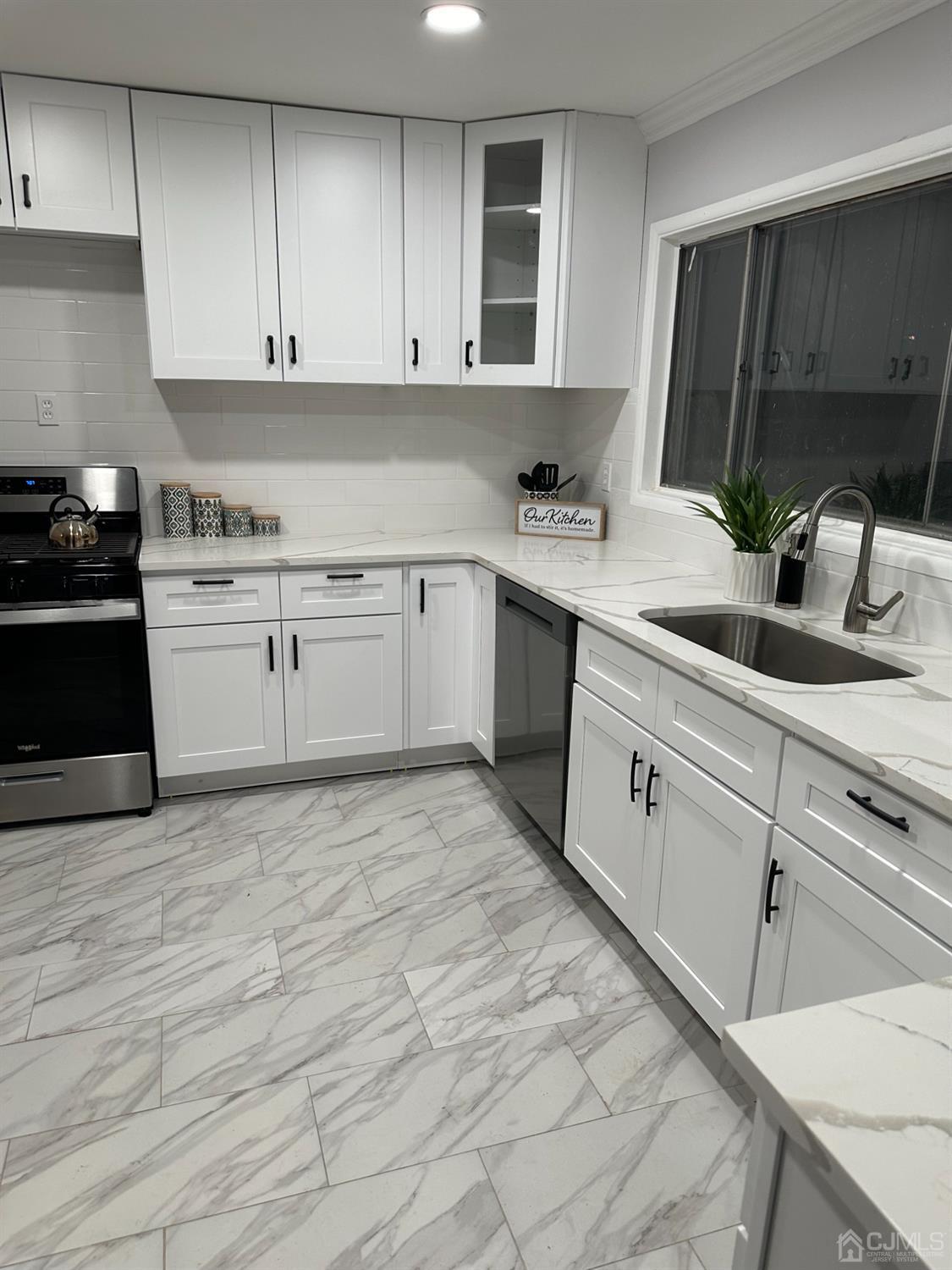 45 Raleigh Road Kendall Park, NJ 08824 - Photo 10 of 13 a kitchen with a cabinets and white appliances