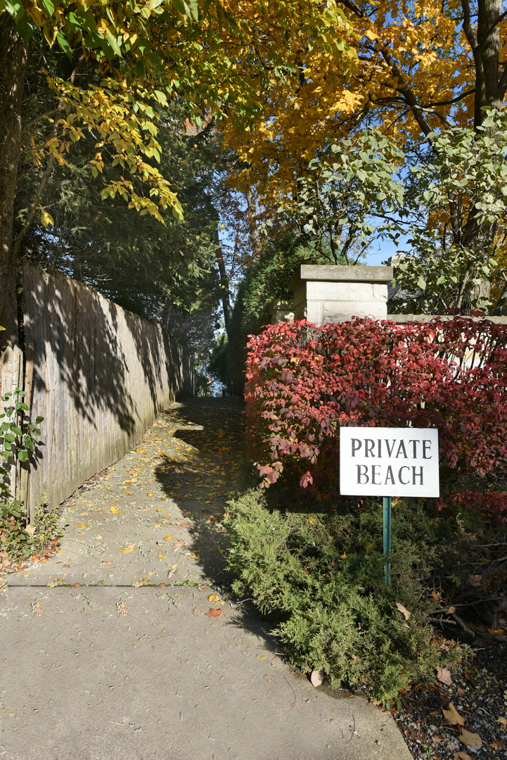 851 Sheridan Road Winnetka, IL 60093 - Photo 60 of 66 a sign that is sitting in front of a tree