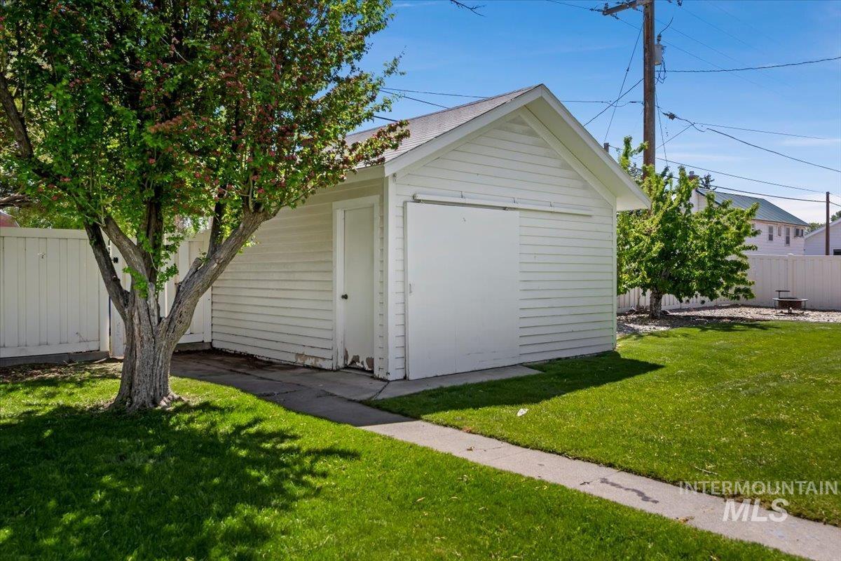 813 7th Street Rupert, ID 83350 - Photo 41 of 48 Detached white garage featuring a side entry door and a sliding garage door