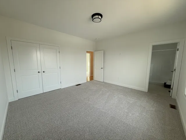 a large kitchen with cabinets wooden floor and stainless steel appliances