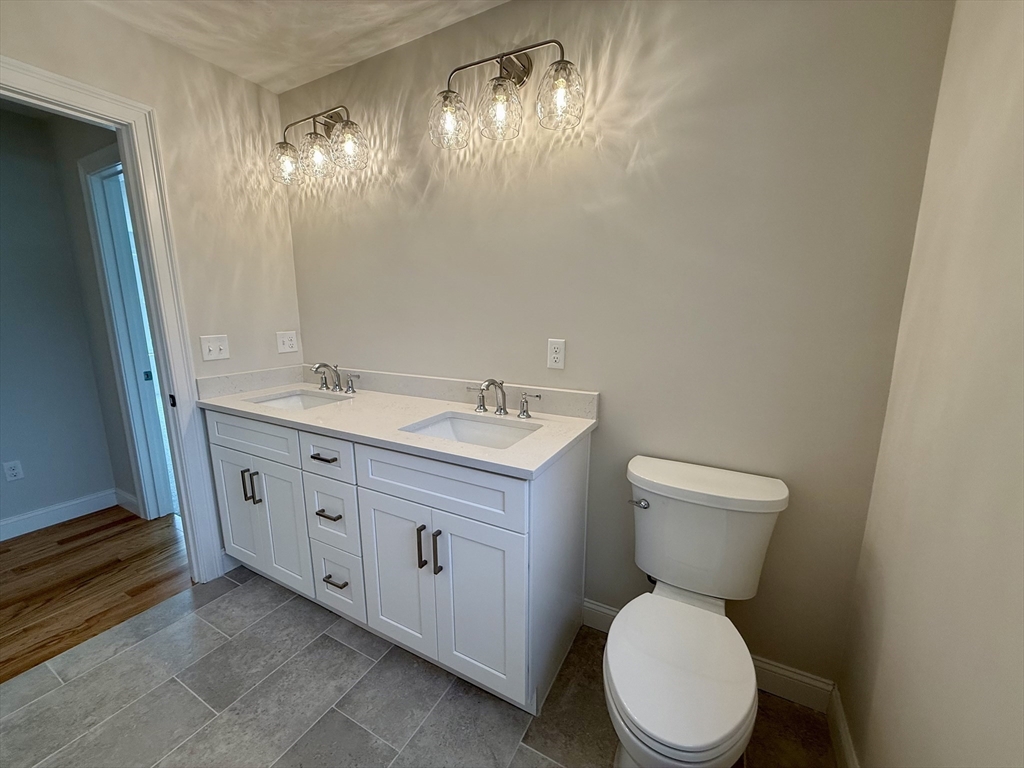 70 Oswego Street Bellingham, MA 02019 - Photo 16 of 28 a bathroom with a toilet sink and mirror