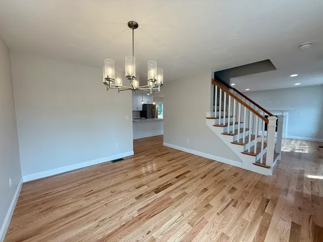 a view of an empty room and wooden floor