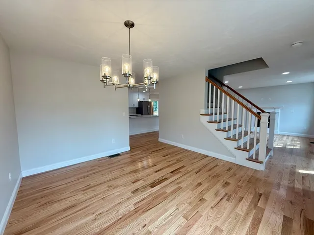 a view of an empty room and wooden floor