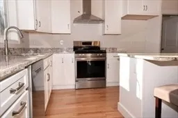 a bathroom with a granite countertop toilet sink and mirror