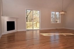 70 Oswego Street Bellingham, MA 02019 - Photo 21 of 28 an empty room with wooden floor and windows