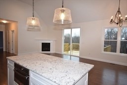 70 Oswego Street Bellingham, MA 02019 - Photo 24 of 28 a kitchen with kitchen island granite countertop wooden floor and a chandelier