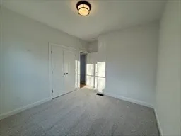 a bathroom with a granite countertop toilet sink and mirror