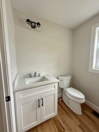 70 Oswego Street Bellingham, MA 02019 - Photo 27 of 28 a bathroom with a granite countertop toilet sink and mirror