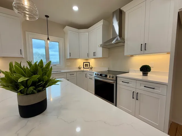a kitchen with a sink a refrigerator and wooden floor