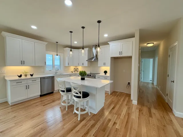 a bathroom with a double vanity sink toilet and a mirror