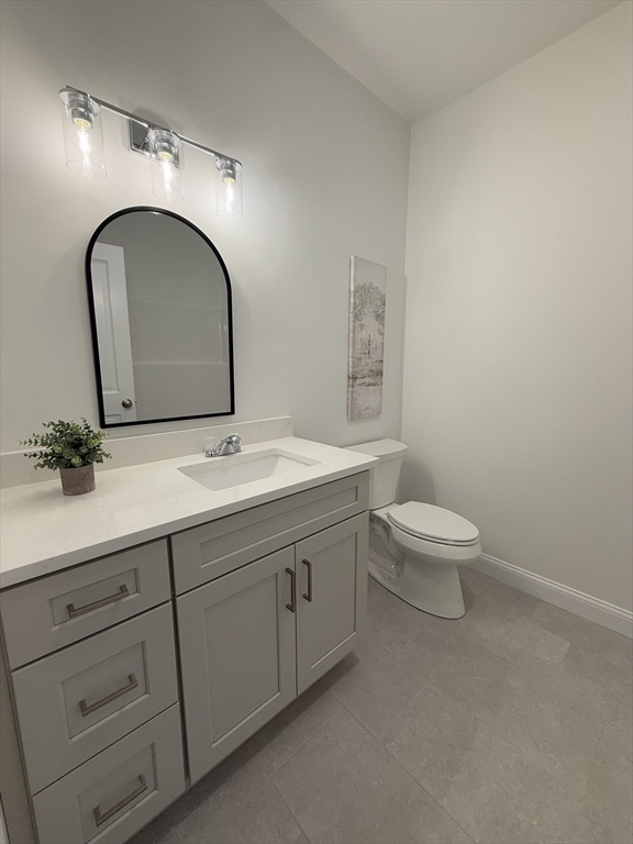 70 Oswego Street Bellingham, MA 02019 - Photo 10 of 28 a bathroom with a double vanity sink toilet and a mirror