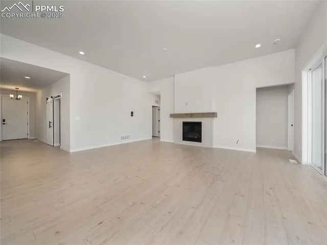 a view of empty room with a fireplace