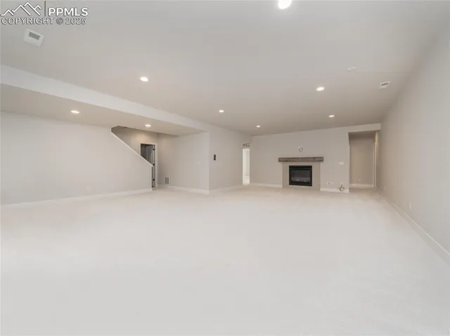 an empty room with an entryway and closet area