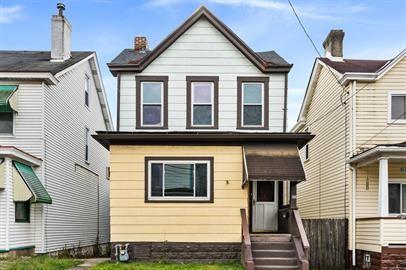 a view of a house with wooden fence