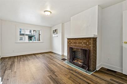 915 2nd Street McKees Rocks, PA 15136 - Photo 4 of 17 a view of an empty room with wooden floor fireplace and a window