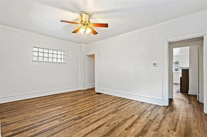 915 2nd Street McKees Rocks, PA 15136 - Photo 6 of 17 a view of an empty room with wooden floor and a ceiling fan