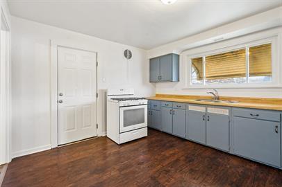 915 2nd Street McKees Rocks, PA 15136 - Photo 10 of 17 a kitchen with wooden cabinets and white appliances
