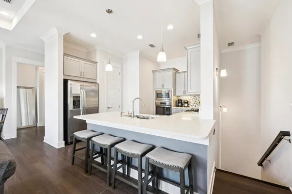 a large kitchen with a table and chairs
