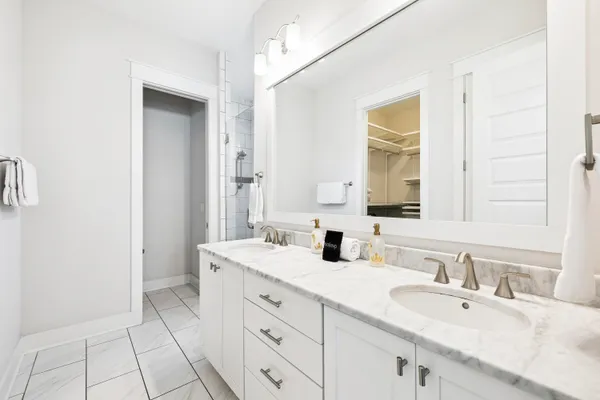 a bathroom with a sink double vanity and a mirror