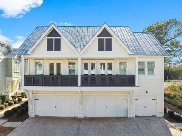 a view of a white house with large windows