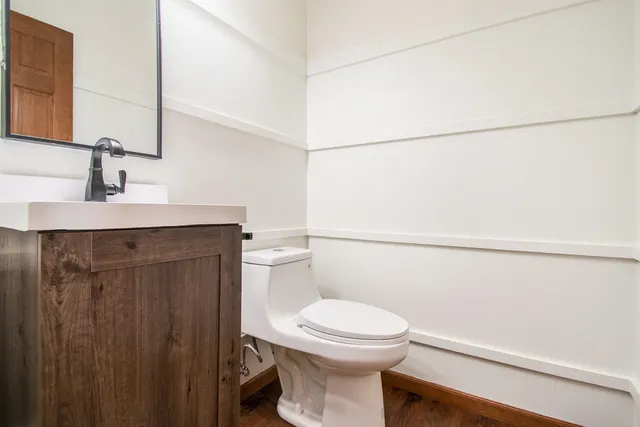 a bathroom with a toilet a sink and vanity