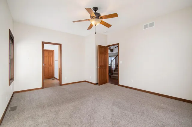 a view of an empty room with a ceiling fan