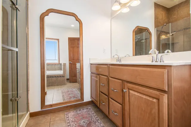 a bathroom with mirror sink and vanity
