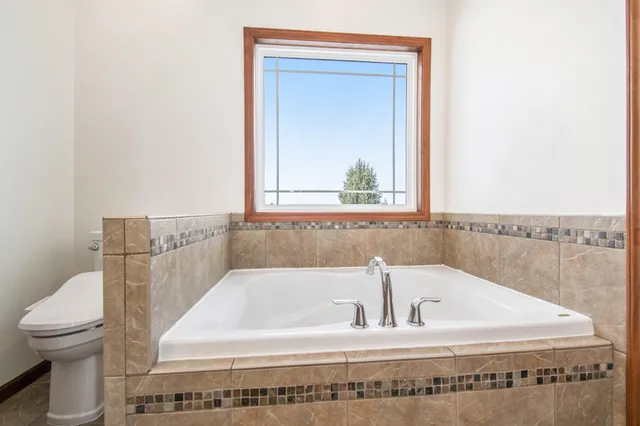 a bathroom with a bathtub and a toilet