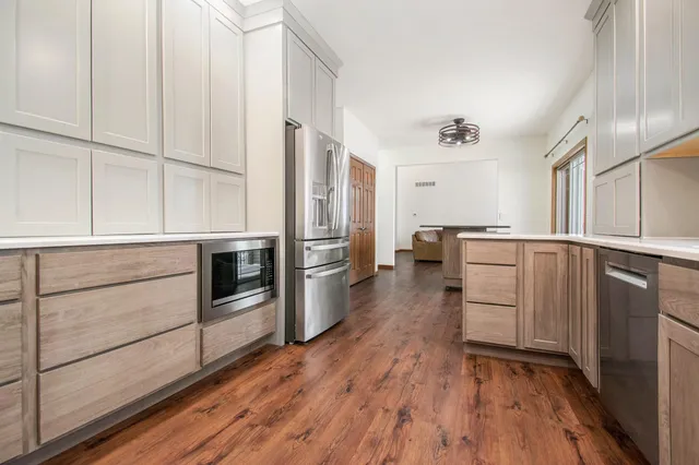 a kitchen with granite countertop white cabinets and white appliances