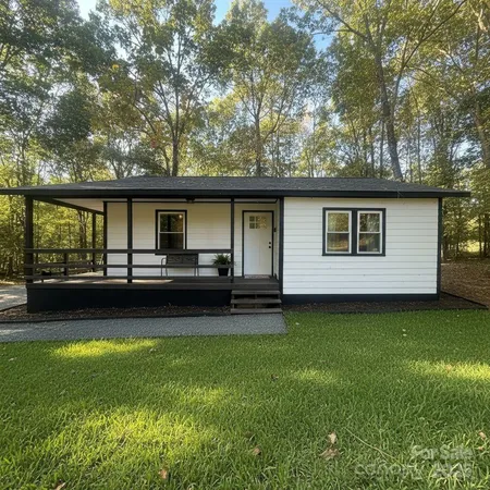 a view of a house with a yard and sitting area