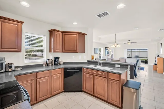 a utility room with fridge dryer and washer