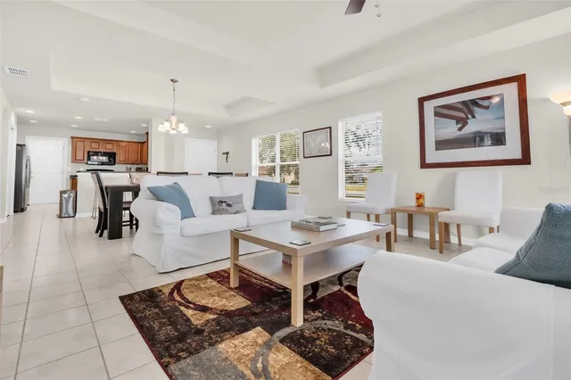 a living room with furniture a table and a window