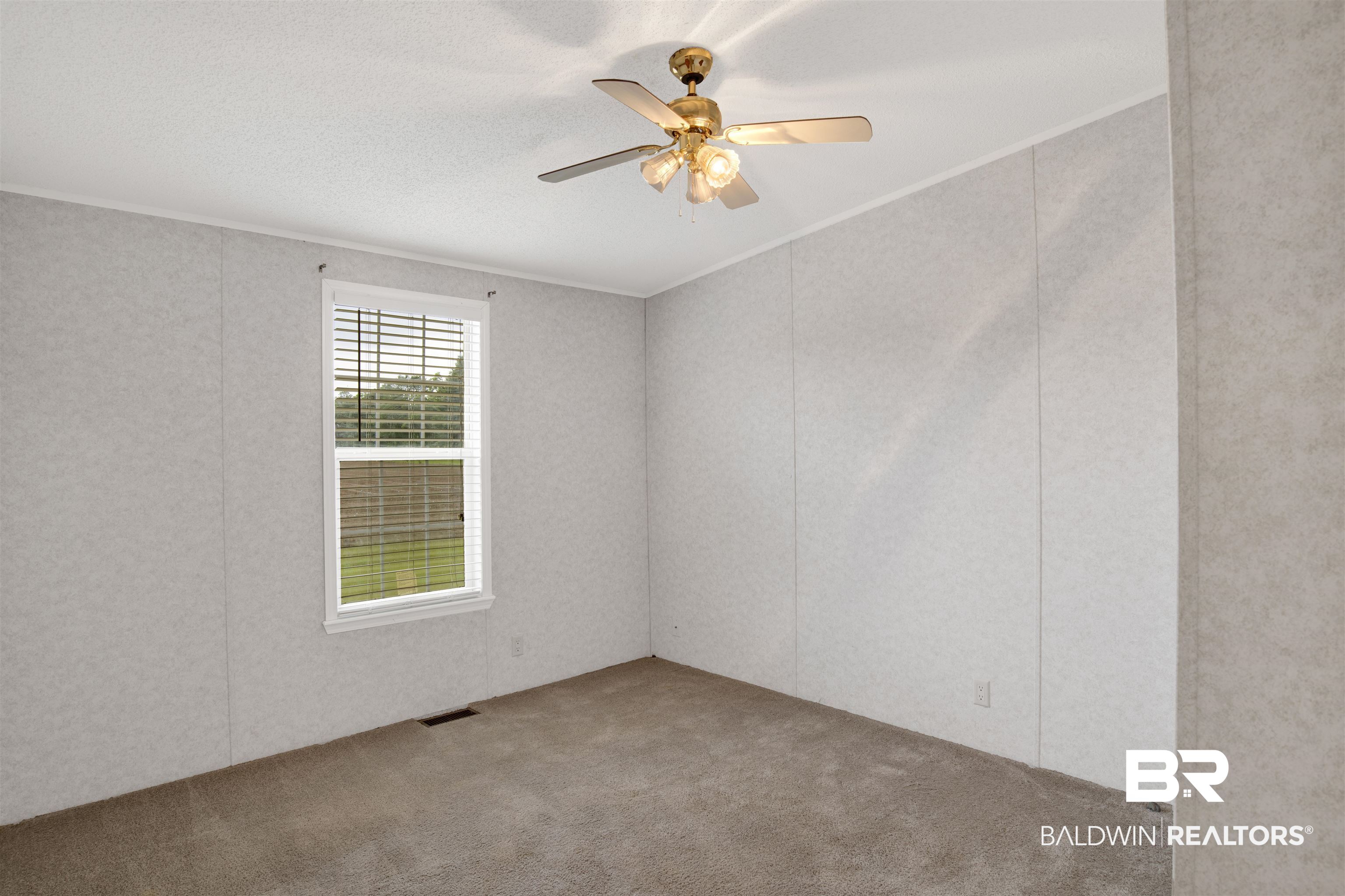 25700 County Road 71 Robertsdale, AL 36567 - Photo 16 of 40 Unfurnished room with carpet flooring, ornamental molding, and ceiling fan
