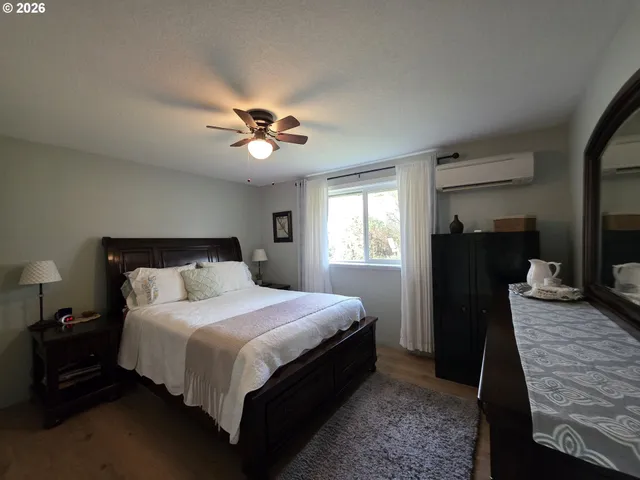 a bedroom with a bed and a book shelf