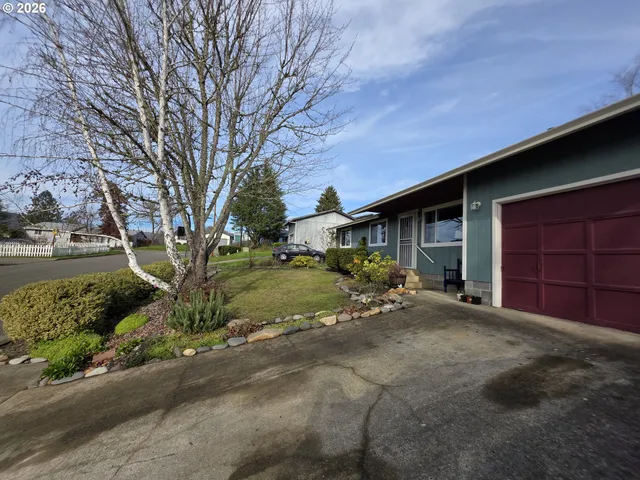 a view of a house with a yard and garage