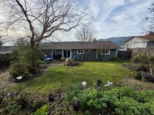 a yellow house in middle of the forest