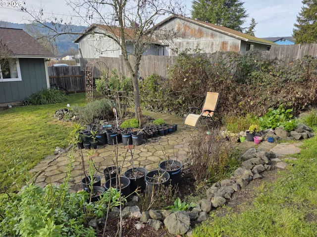 a front view of house with yard and trees around